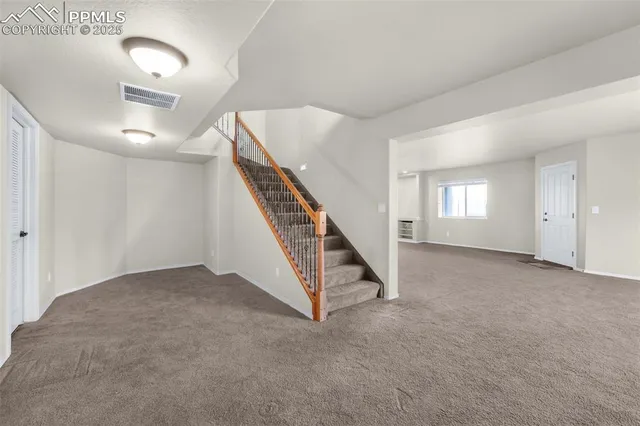 a kitchen with a refrigerator a sink and dishwasher with wooden cabinets