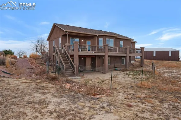 an aerial view of a house with a yard and lake view
