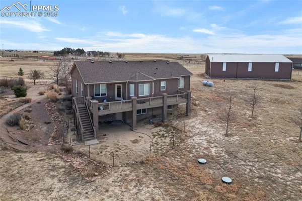 an aerial view of a house with a yard and lake view