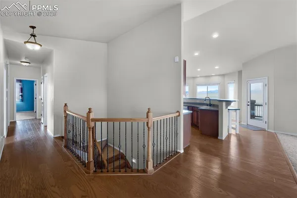 a kitchen with stainless steel appliances granite countertop a refrigerator sink and wooden cabinets