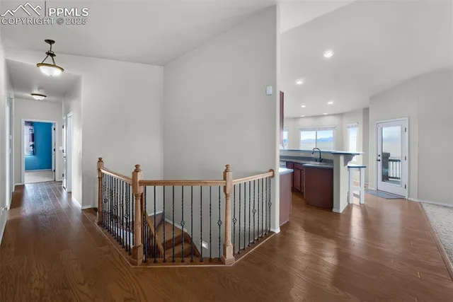 a kitchen with stainless steel appliances granite countertop a refrigerator sink and wooden cabinets