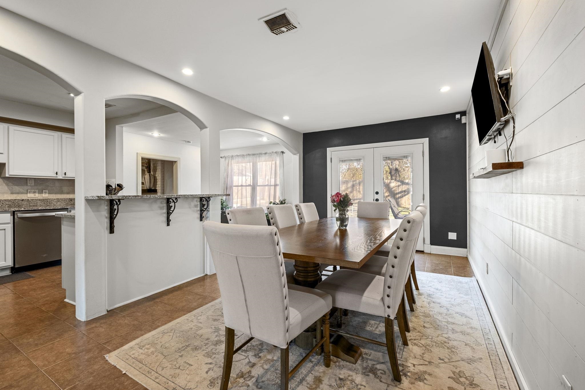 4120 Village Road Memphis, TN 38117 - Photo 12 of 28 Dining area with french doors, arched walkways, recessed lighting, and dark tile patterned floors