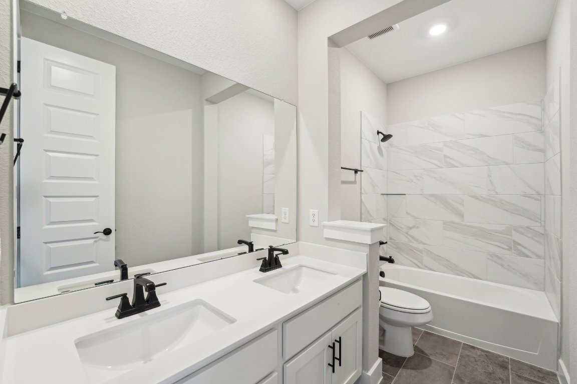 4216 Caroline Mae Cove Pflugerville, TX 78660 - Photo 11 of 32 a bathroom with a sink a toilet and shower