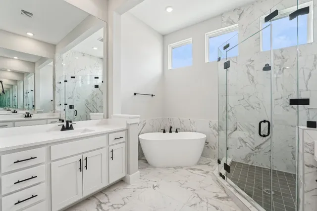 a spacious bathroom with a double vanity sink mirror double and bathtub