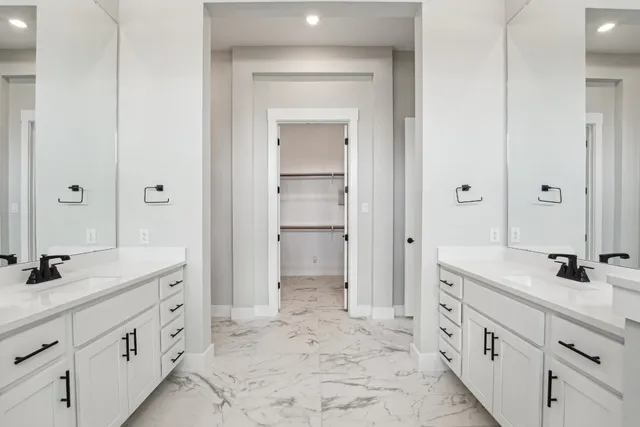 a spacious bathroom with a granite countertop sink mirror and a