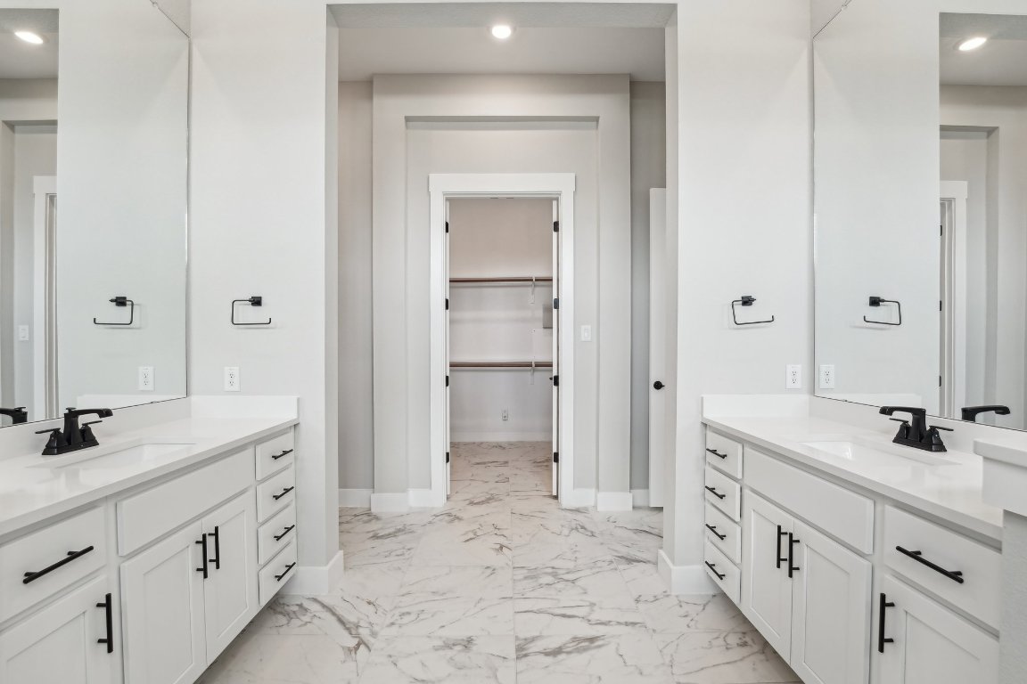4216 Caroline Mae Cove Pflugerville, TX 78660 - Photo 24 of 32 a spacious bathroom with a granite countertop sink mirror and a