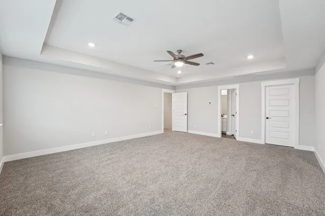 a view of an empty room with a ceiling fan