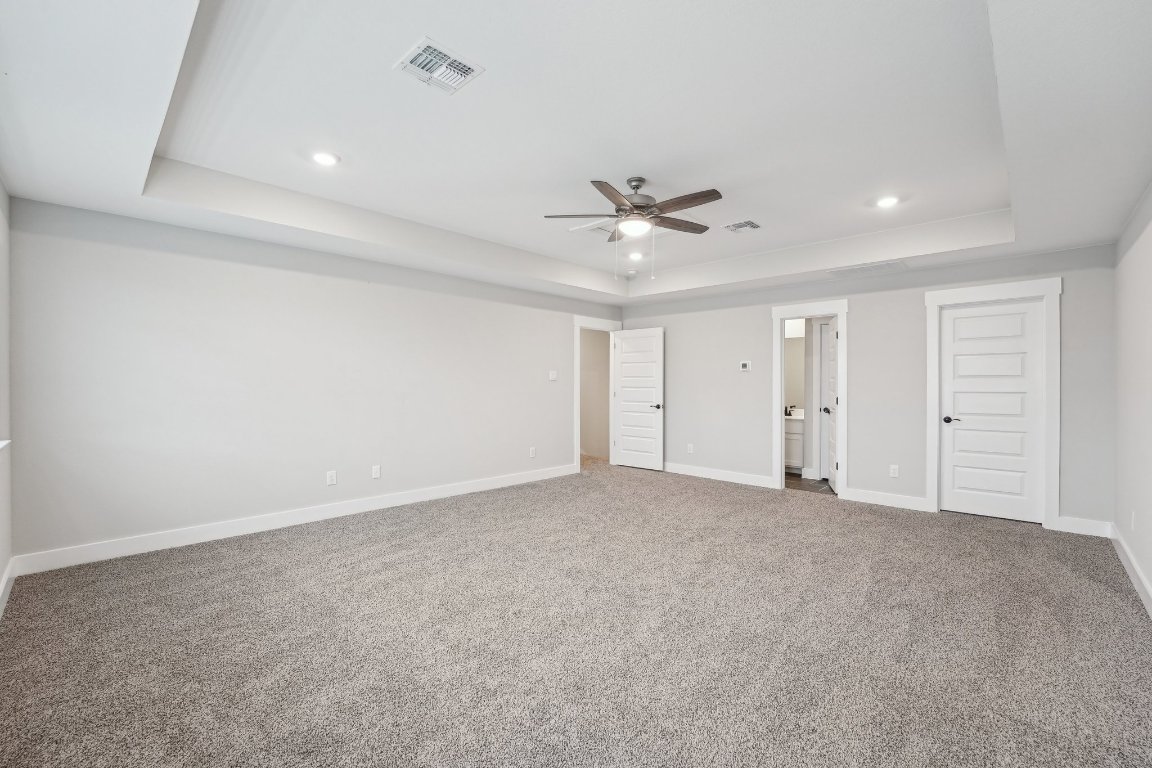 4216 Caroline Mae Cove Pflugerville, TX 78660 - Photo 28 of 32 a view of an empty room with a ceiling fan