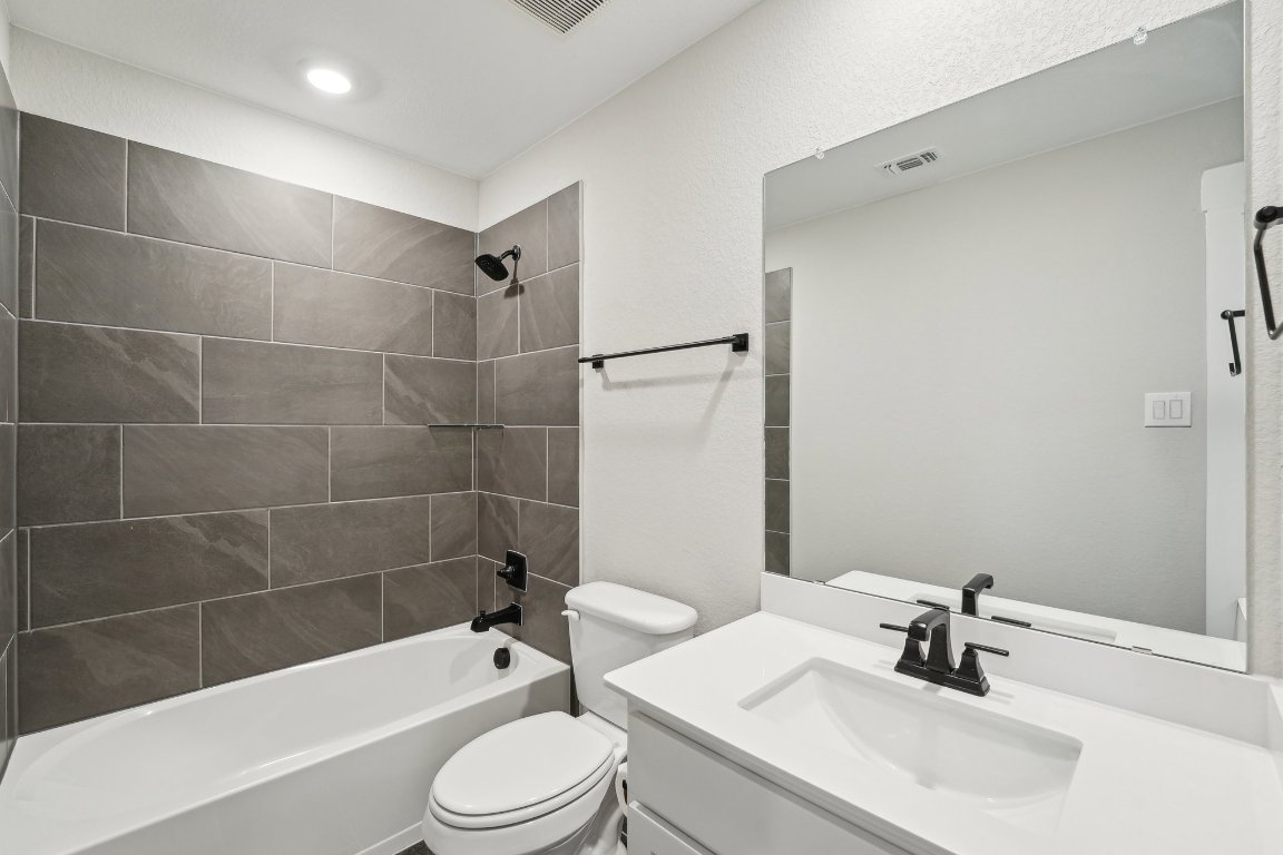 4216 Caroline Mae Cove Pflugerville, TX 78660 - Photo 30 of 32 a bathroom with a sink a toilet and bathtub