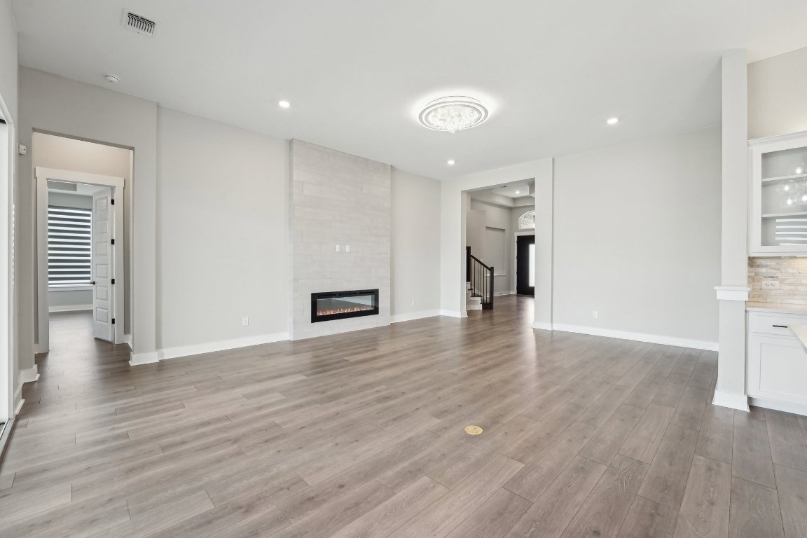 4216 Caroline Mae Cove Pflugerville, TX 78660 - Photo 3 of 32 a view of a livingroom with wooden floor