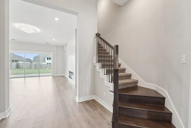 a view of entryway and hall with wooden floor