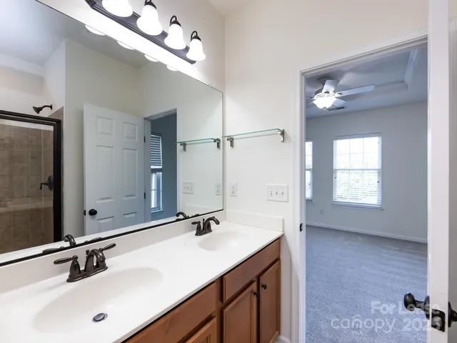 a bathroom with a double vanity sink and a mirror