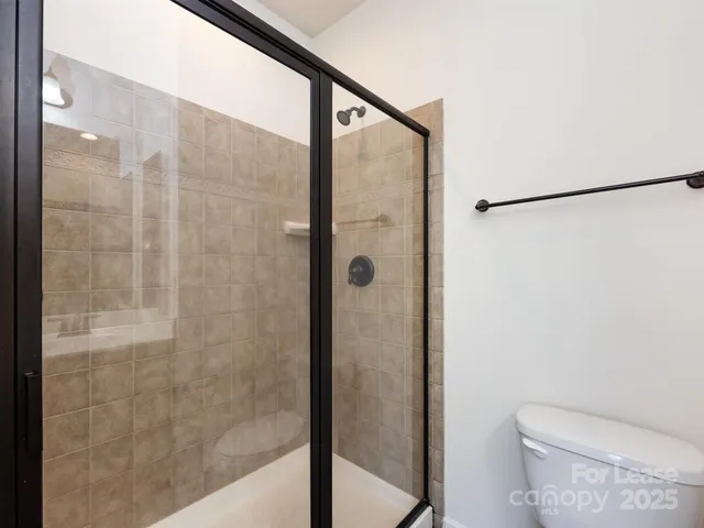 a bathroom with a shower and a toilet