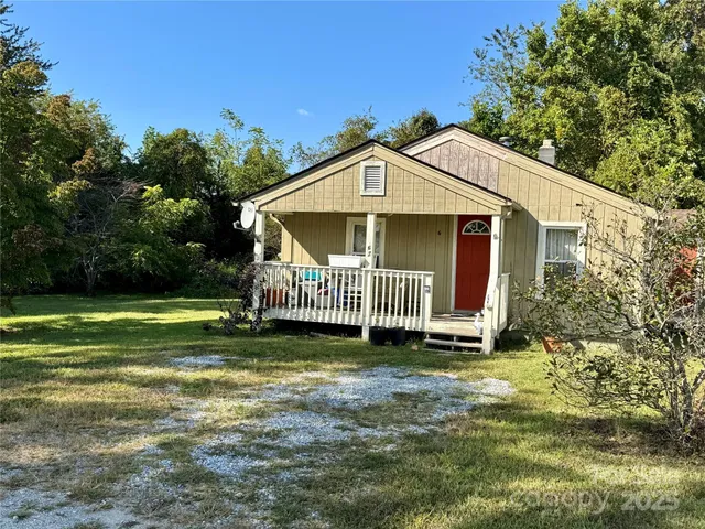 a view of a house with a yard and deck
