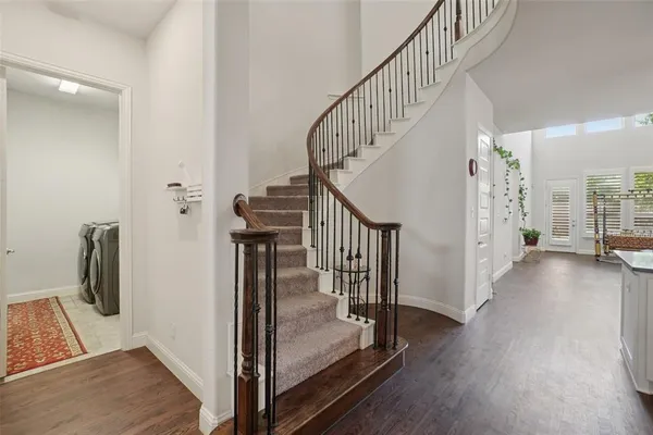 a view of entryway and hall with wooden floor
