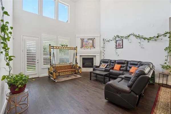 a living room with furniture a fireplace and a potted plant