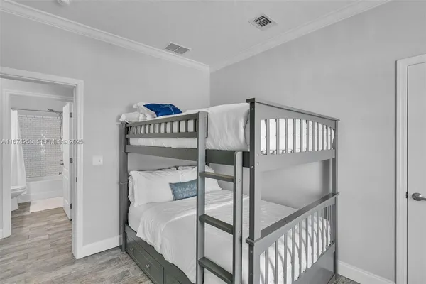 a bedroom with a bunk bed and a dresser