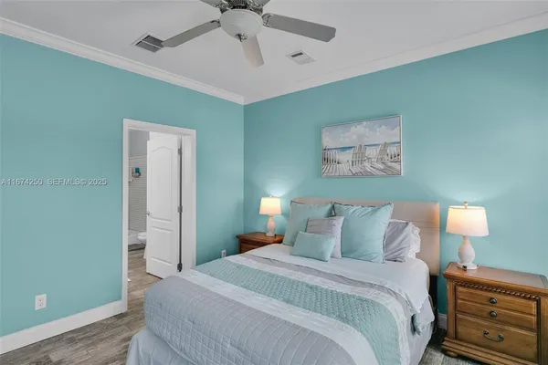 a bedroom with a bed and a lamp on the dresser