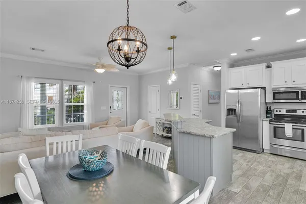 a very nice looking dining room with furniture window and wooden floor