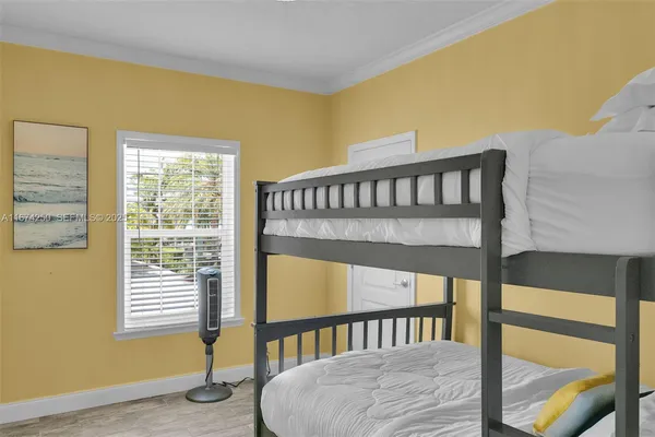 a bedroom with a bed and window