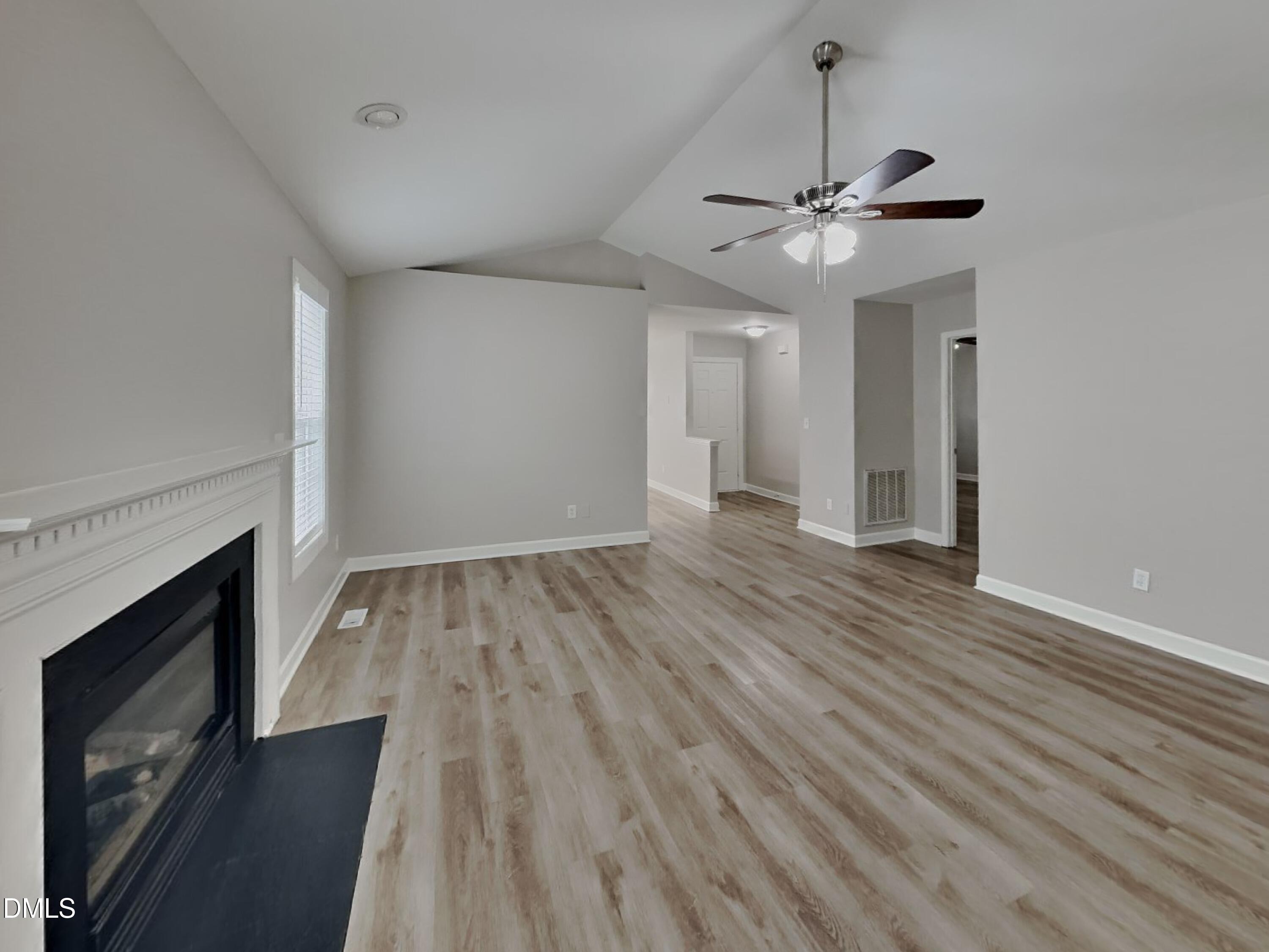 3224 Cotton Grove Raleigh, NC 27610 - Photo 2 of 15 wooden floor in an empty room with a fireplace