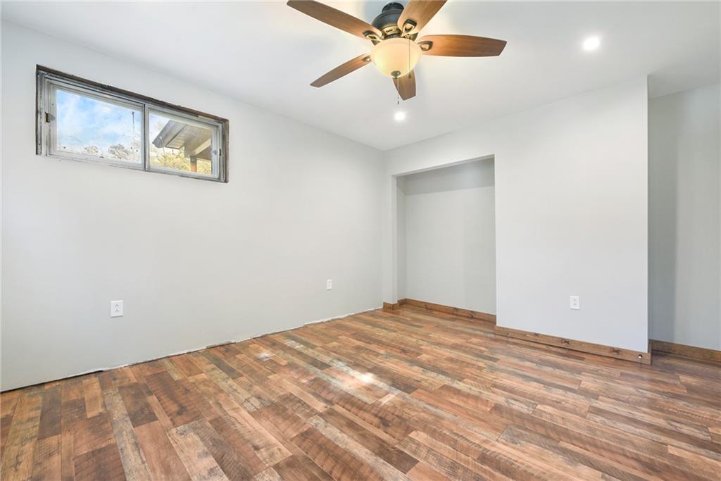 1190 Rte 481 Charleroi, PA 15022 - Photo 16 of 32 a view of an empty room with wooden floor and a ceiling fan