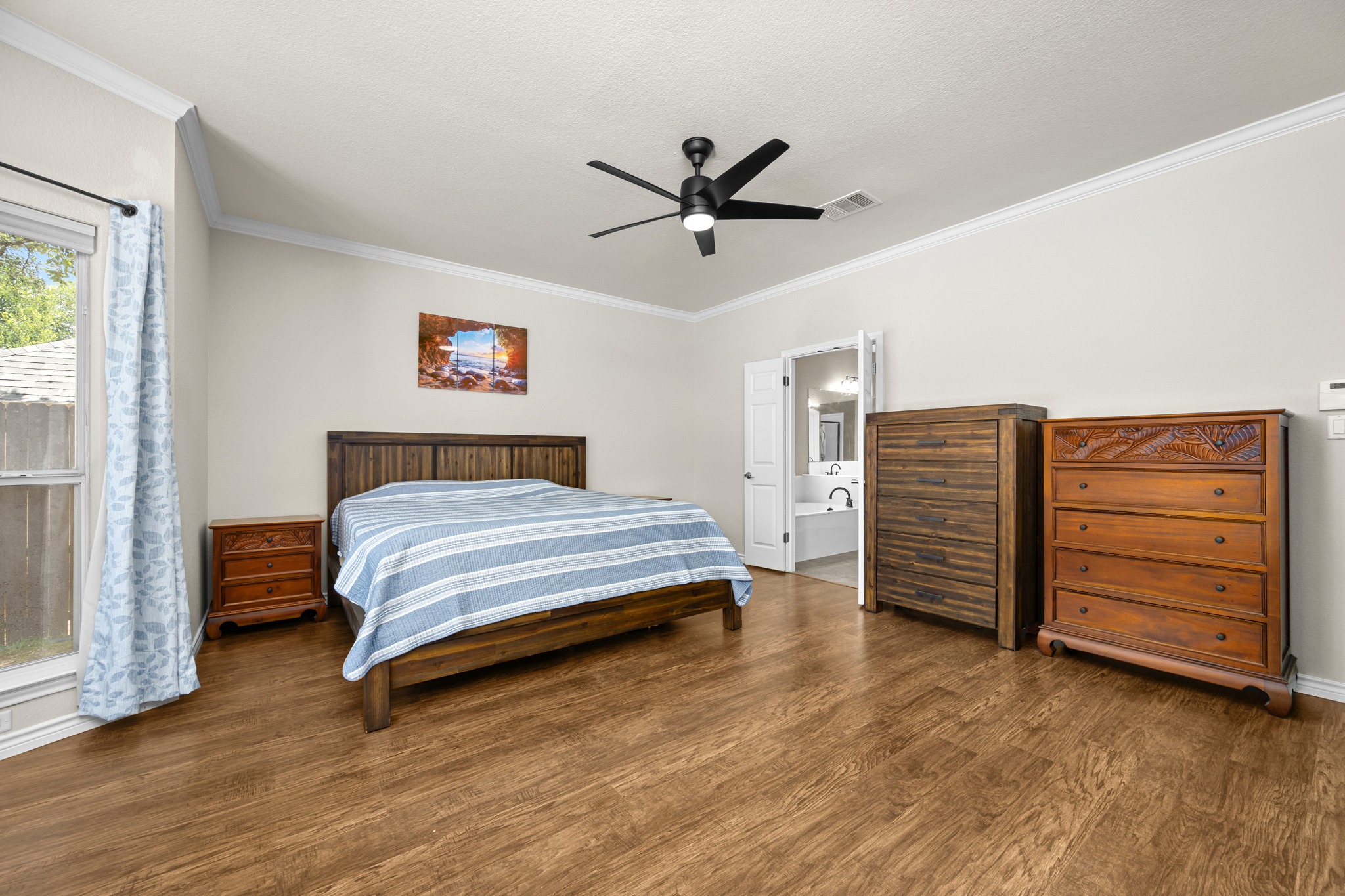 108 Thornwood Road Georgetown, TX 78628 - Photo 20 of 40 Relax in a cozy bedroom featuring rich wood-look flooring and a modern ceiling fan.