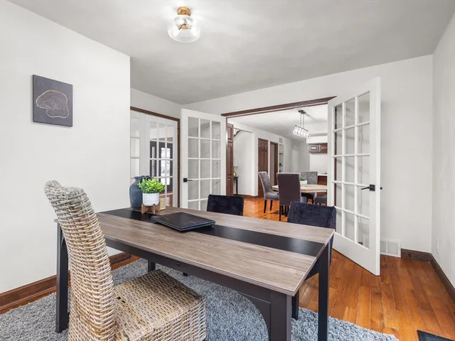 a view of a dining room with furniture window and wooden floor