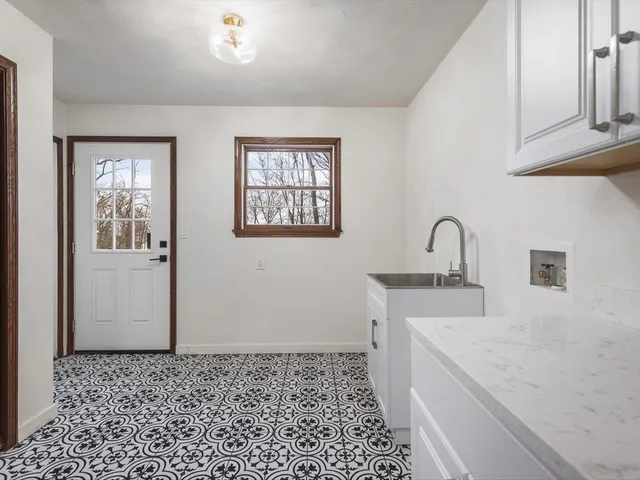a view of a livingroom with furniture and staircase