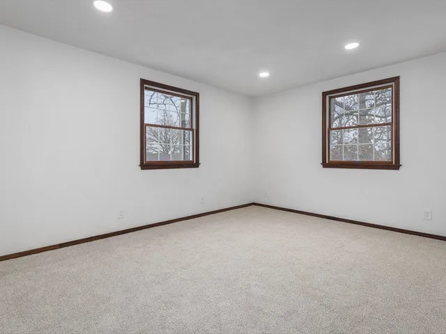 an aerial view of a house with a yard and swimming pool