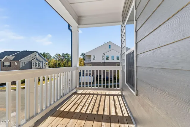 a view of a balcony with wooden floor