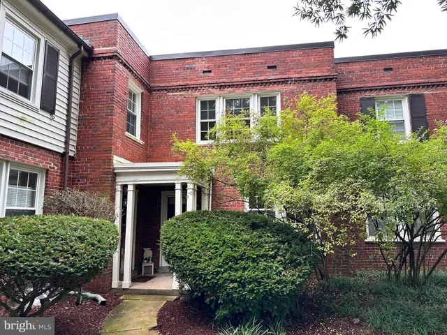 front view of a house with a tree