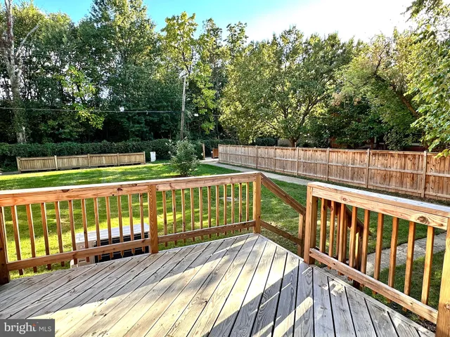 a view of balcony with wooden floor and fence