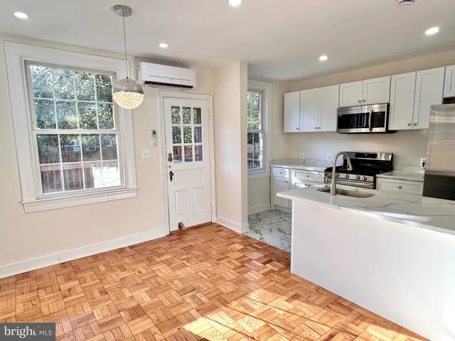a kitchen with stainless steel appliances granite countertop a refrigerator sink and microwave