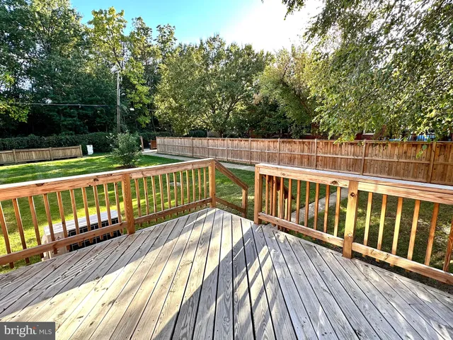 a view of balcony with wooden floor and fence