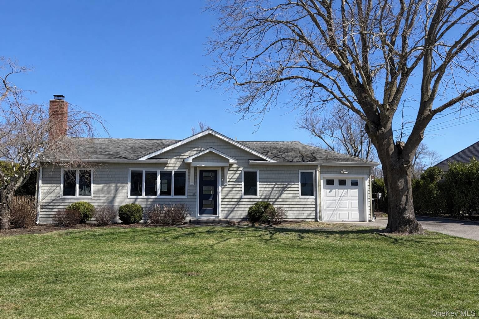 21 Tarpon Road East Quogue, NY 11942 - Photo 1 of 18 a front view of house with yard and green space