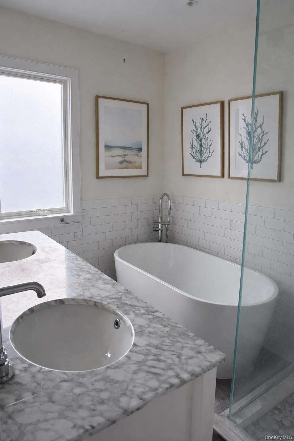 21 Tarpon Road East Quogue, NY 11942 - Photo 12 of 18 a bathroom with a tub a sink and a window
