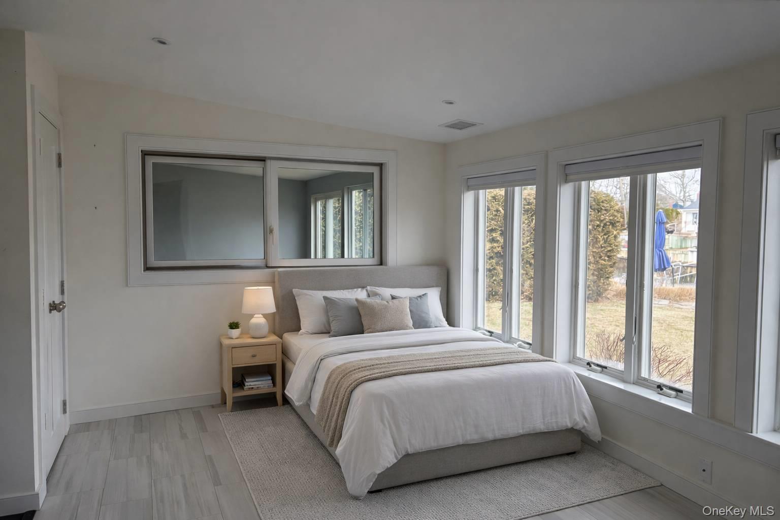 21 Tarpon Road East Quogue, NY 11942 - Photo 13 of 18 a bedroom with a bed and a large window