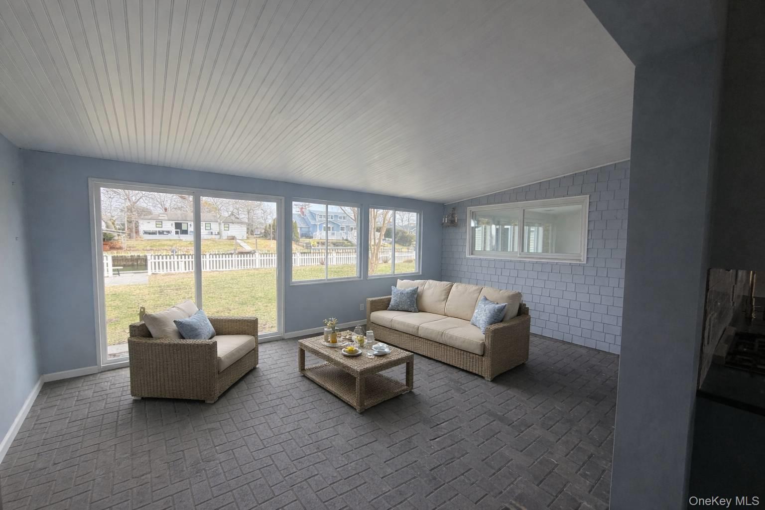 21 Tarpon Road East Quogue, NY 11942 - Photo 16 of 18 a living room with furniture and a large window
