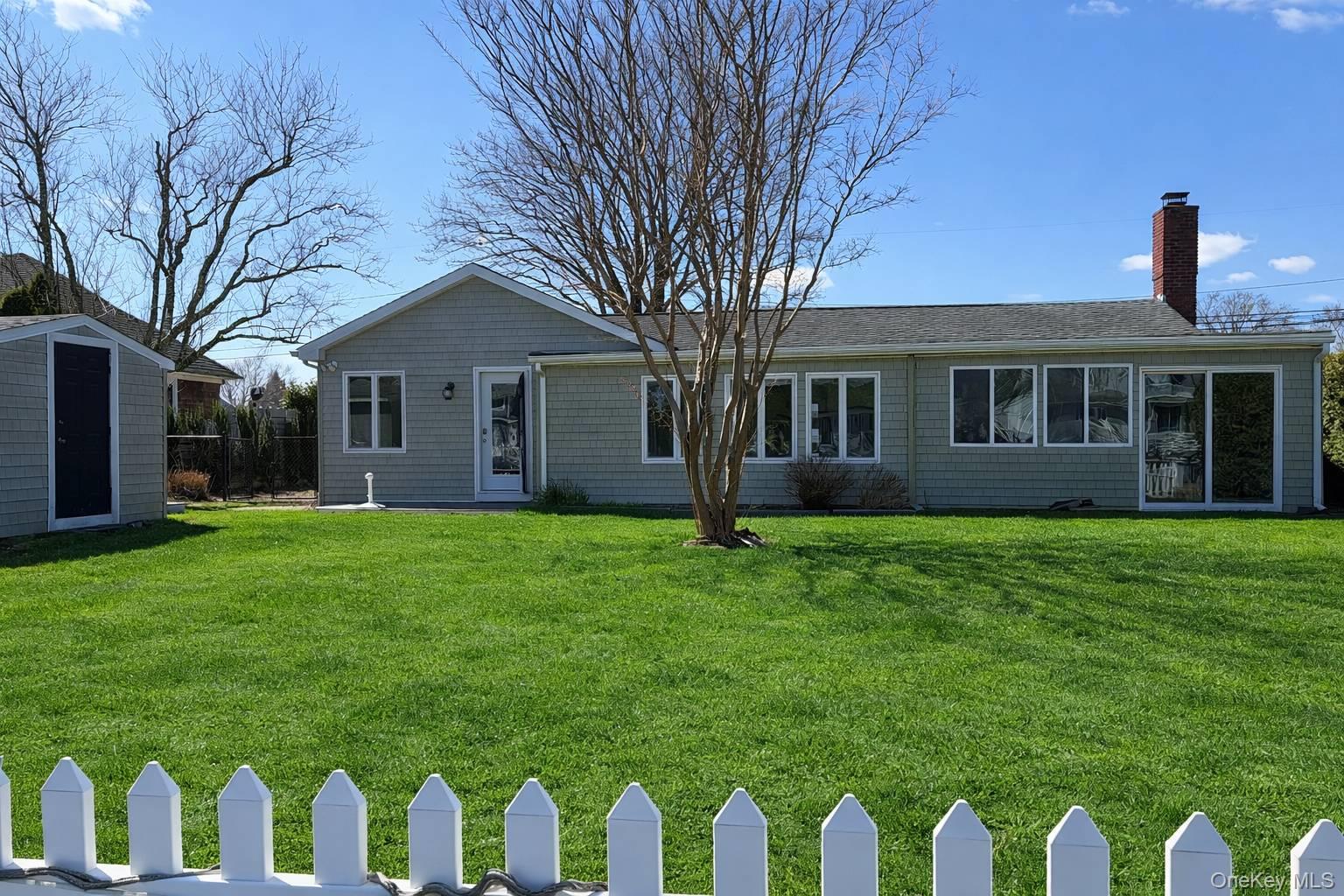 21 Tarpon Road East Quogue, NY 11942 - Photo 5 of 18 a front view of house with a garden