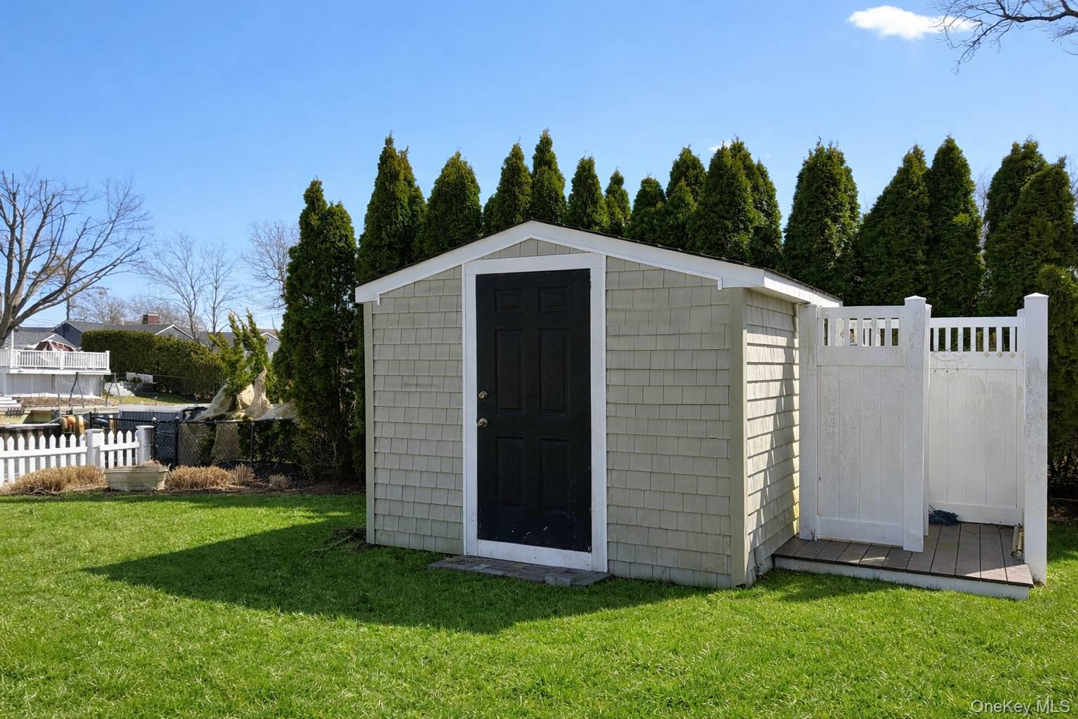 21 Tarpon Road East Quogue, NY 11942 - Photo 6 of 18 a front view of a house with garden