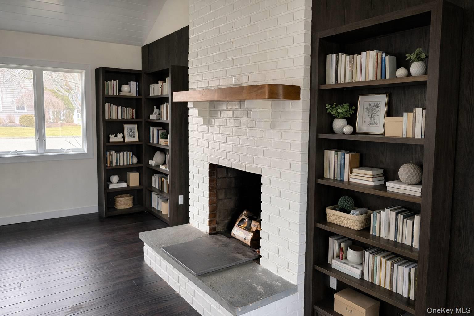 21 Tarpon Road East Quogue, NY 11942 - Photo 10 of 18 a living room with hard wood floors and a fireplace