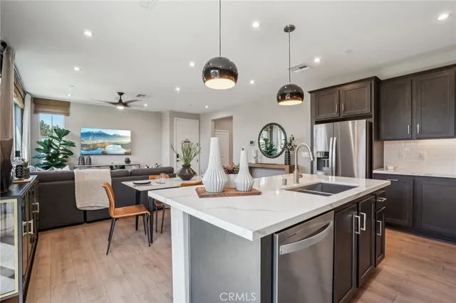 a kitchen with stainless steel appliances granite countertop a sink stove and cabinets