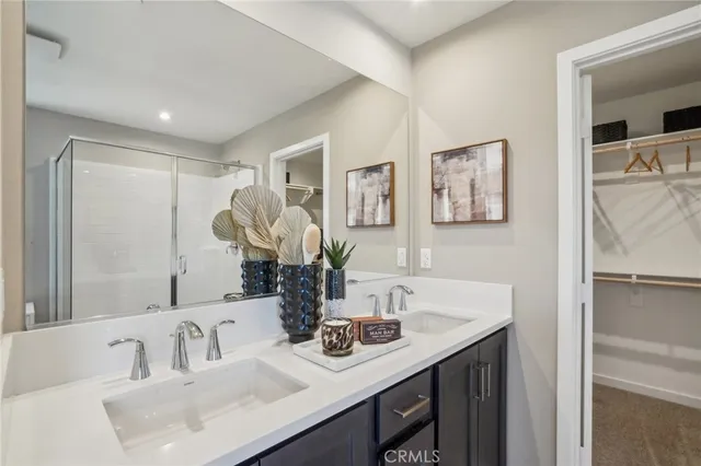 a bathroom with a sink shower and a mirror