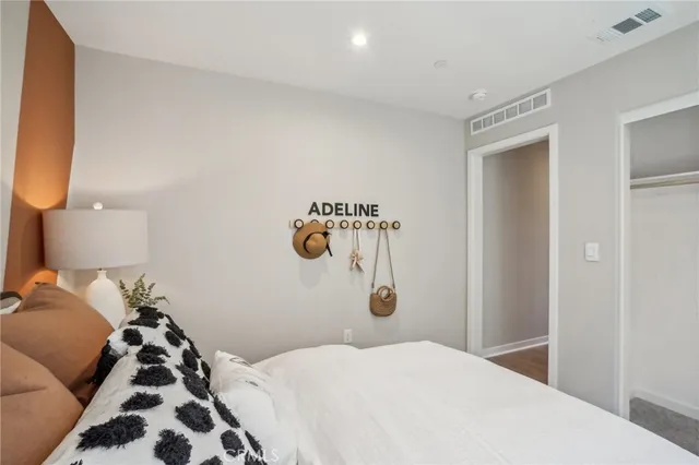 a bedroom with windows and entrance