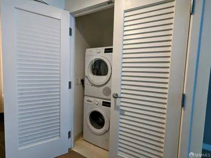 a kitchen with kitchen island sink and refrigerator
