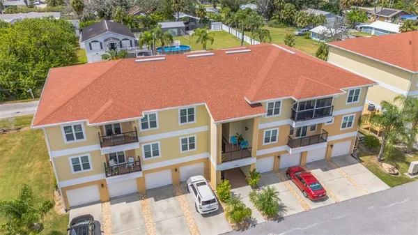 an aerial view of multiple houses with yard