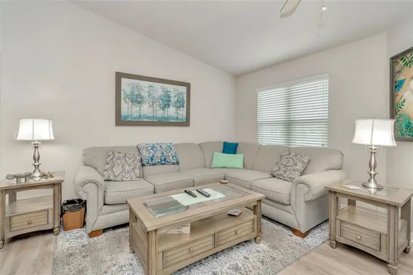 a living room with furniture a lamp and a window