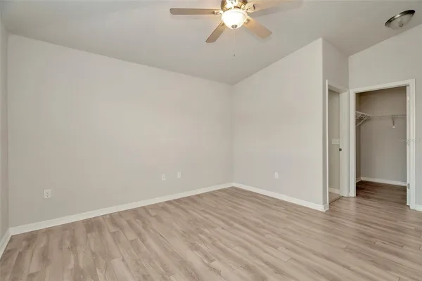 a view of an empty room with wooden floor