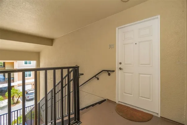 a view of staircase with railing and white walls
